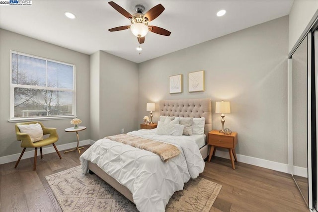 bedroom with ceiling fan, a closet, and hardwood / wood-style floors