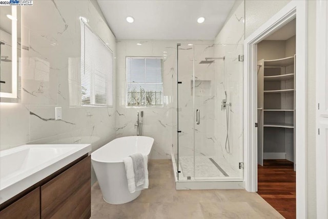 bathroom featuring independent shower and bath and vanity