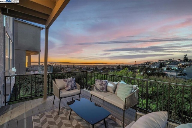 balcony at dusk with an outdoor living space