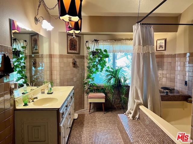 bathroom featuring vanity, shower / bath combo, tile patterned flooring, and tile walls