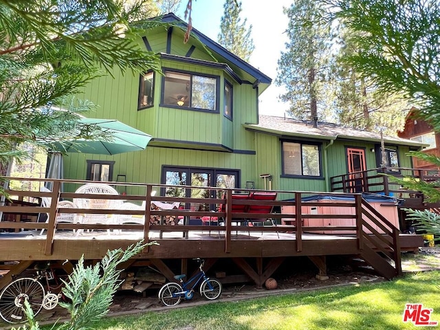 rear view of house with a wooden deck