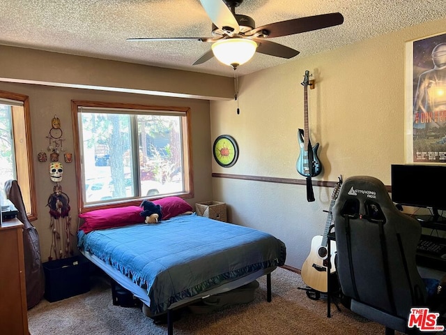 carpeted bedroom with a textured ceiling and ceiling fan