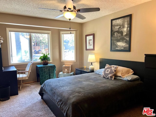 bedroom featuring ceiling fan, carpet, and a textured ceiling