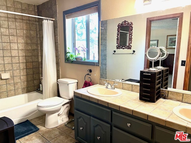 full bathroom featuring tile patterned flooring, shower / bath combo with shower curtain, vanity, and toilet