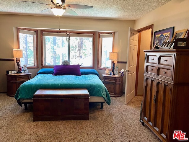 bedroom featuring ceiling fan, light carpet, and multiple windows