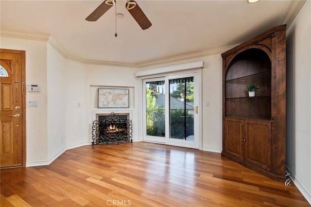 unfurnished living room with ceiling fan, light hardwood / wood-style floors, and ornamental molding