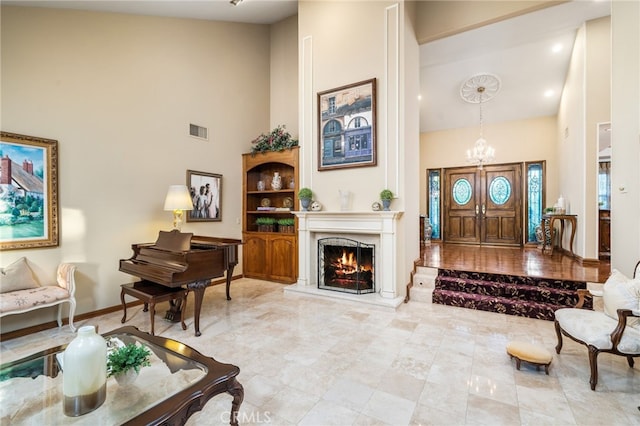 interior space with a high ceiling and a chandelier