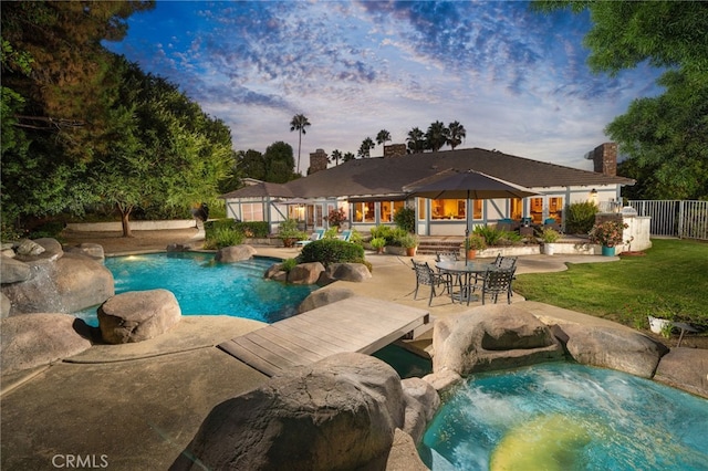 view of pool with a patio area and a yard