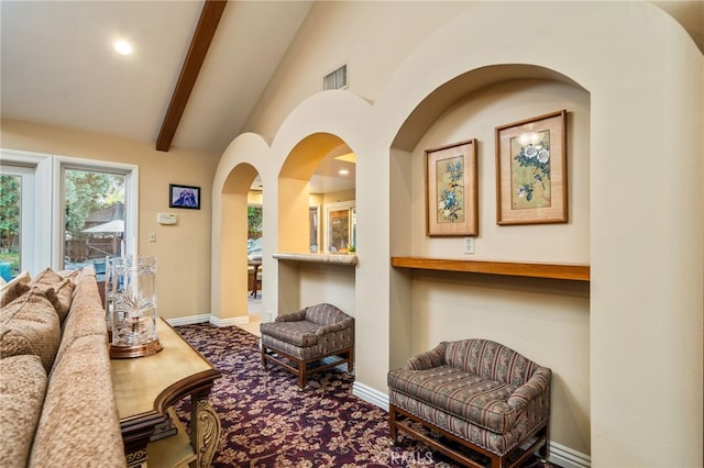 living room with vaulted ceiling with beams