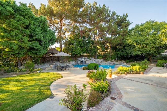 view of pool with a lawn, a gazebo, and a patio area