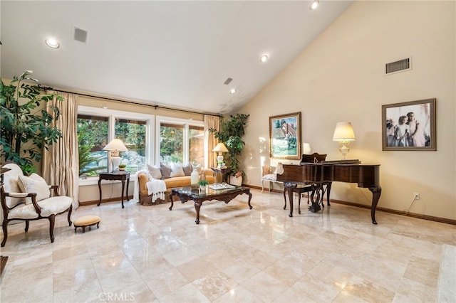 sitting room with high vaulted ceiling