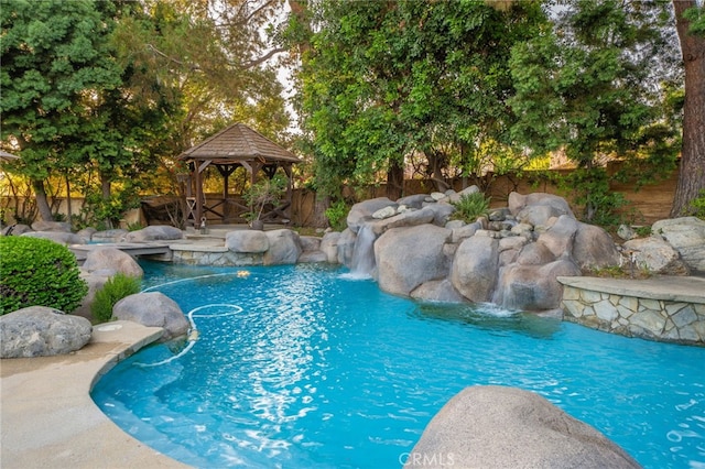 view of pool featuring a gazebo and pool water feature