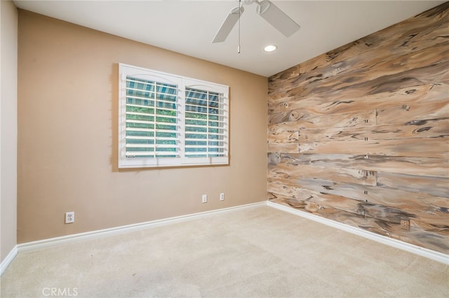 spare room with carpet floors and ceiling fan