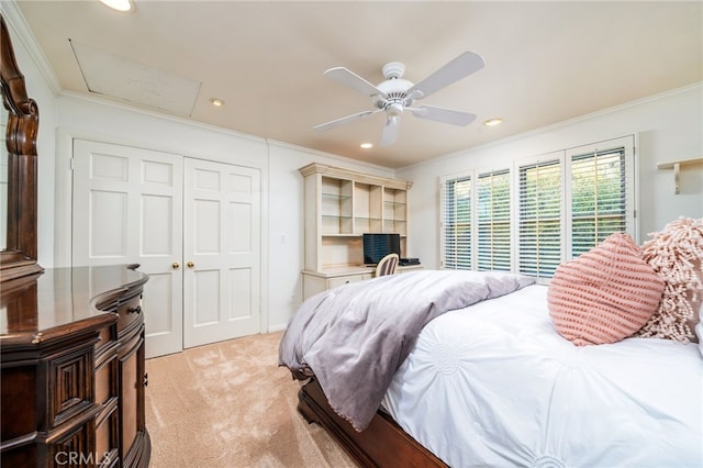 bedroom with a closet, ceiling fan, crown molding, and light colored carpet