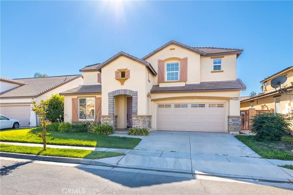 view of front of property with a front yard and a garage