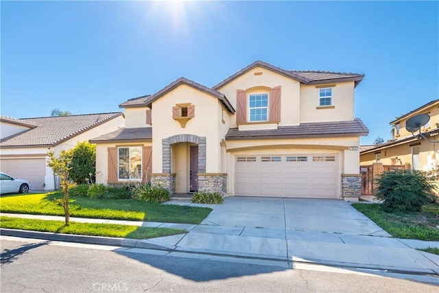 view of front of property with a front yard and a garage