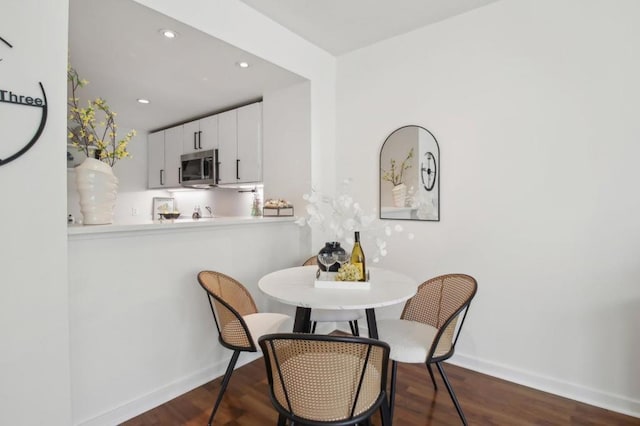 dining room with dark hardwood / wood-style floors