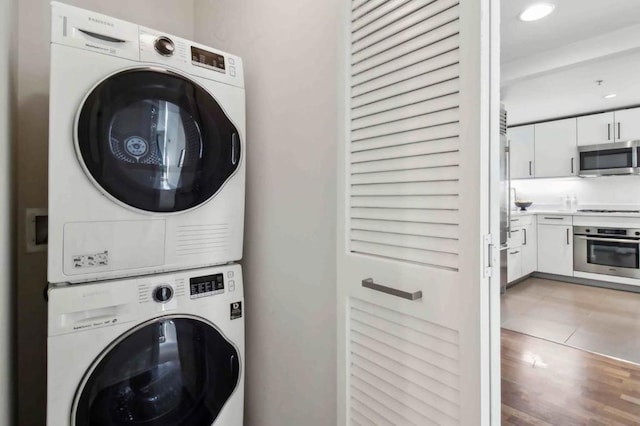 laundry area featuring stacked washer / dryer