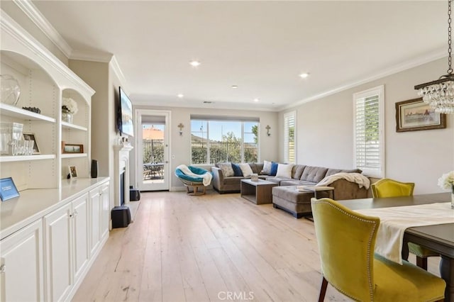 living room with ornamental molding and light hardwood / wood-style flooring