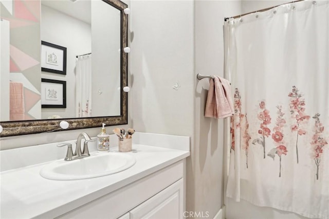 bathroom with walk in shower and vanity