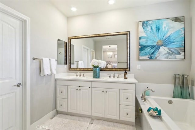 bathroom featuring vanity and a bath