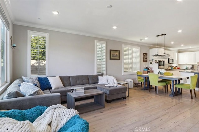 living room with crown molding and light wood-type flooring