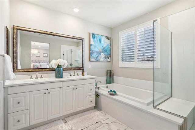 bathroom featuring independent shower and bath and vanity