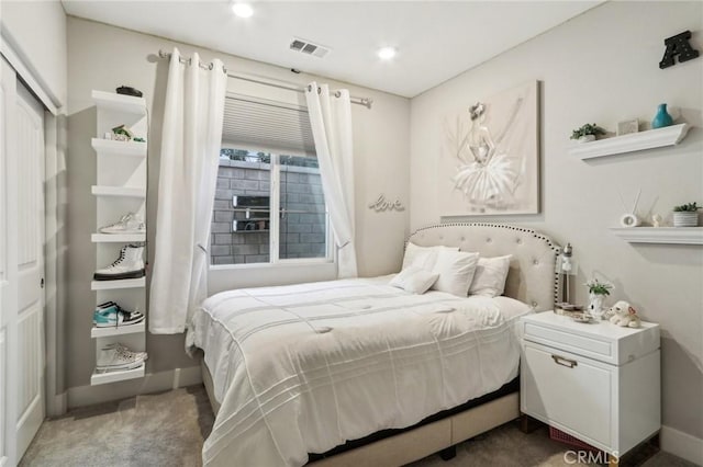 bedroom with dark colored carpet