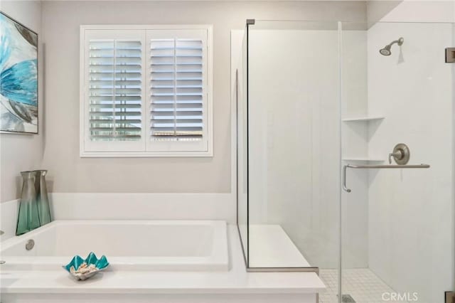 bathroom featuring separate shower and tub