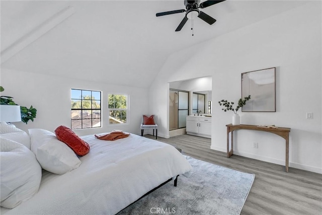 bedroom featuring ensuite bathroom, high vaulted ceiling, ceiling fan, and light wood-type flooring