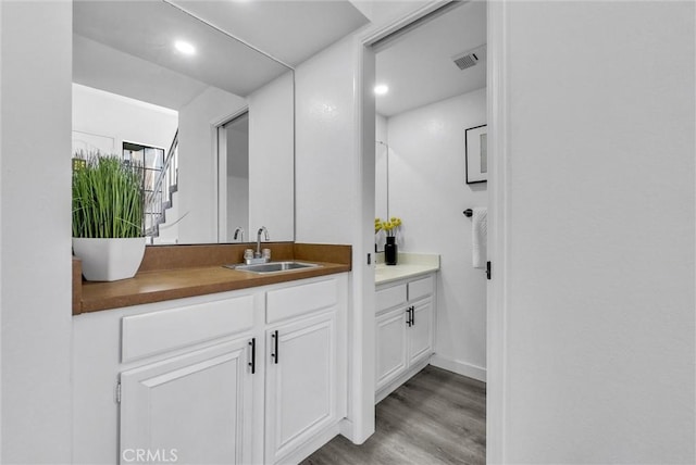 bathroom featuring vanity and hardwood / wood-style flooring