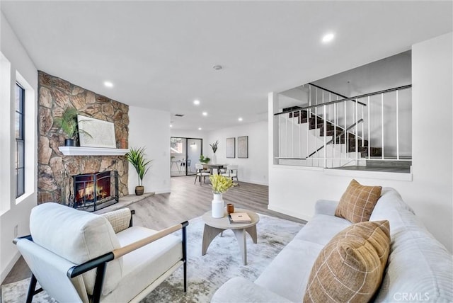 living room with hardwood / wood-style floors and a fireplace