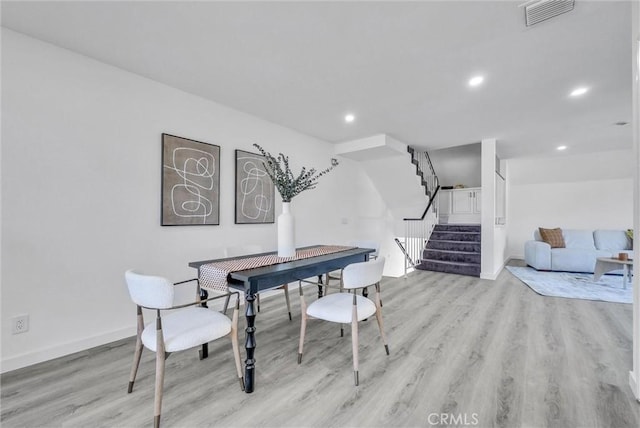 dining space featuring light wood-type flooring