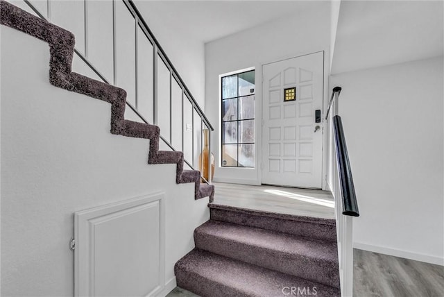 staircase with wood-type flooring