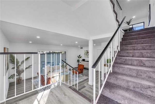 stairs featuring hardwood / wood-style floors