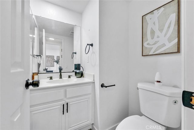 bathroom with toilet and vanity