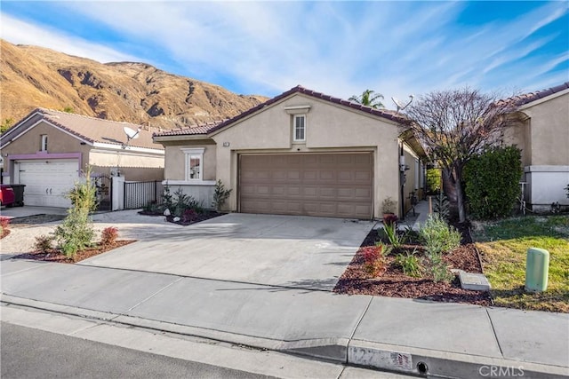 view of front facade with a mountain view and a garage