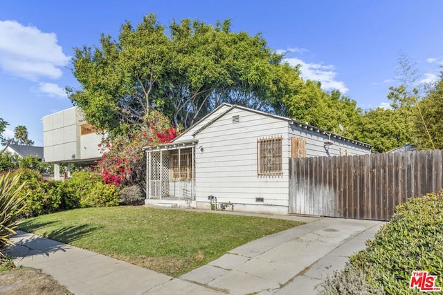 view of side of property with a yard