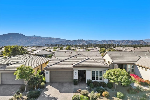 single story home with a garage and a mountain view