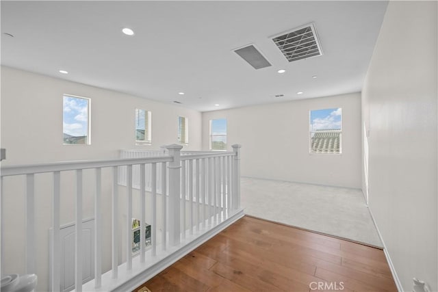 hallway with hardwood / wood-style flooring