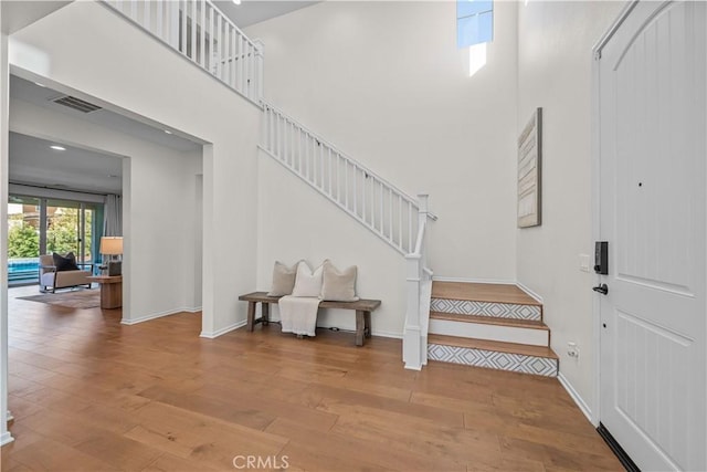 entryway with a high ceiling and hardwood / wood-style floors