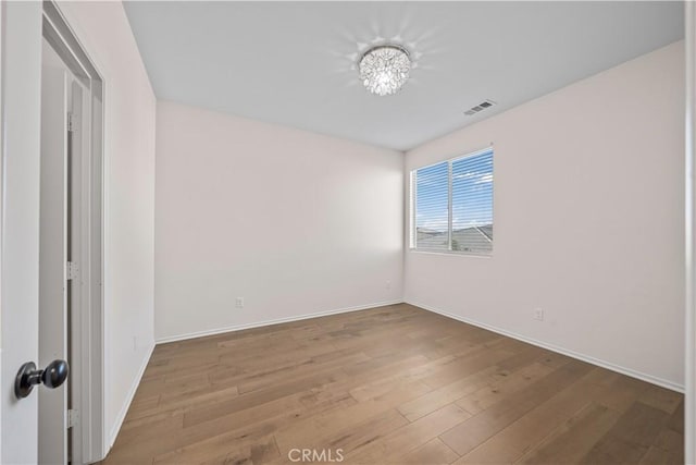 unfurnished room with hardwood / wood-style floors