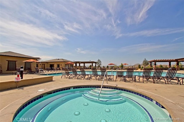 view of pool featuring a pergola, a patio area, and a water view