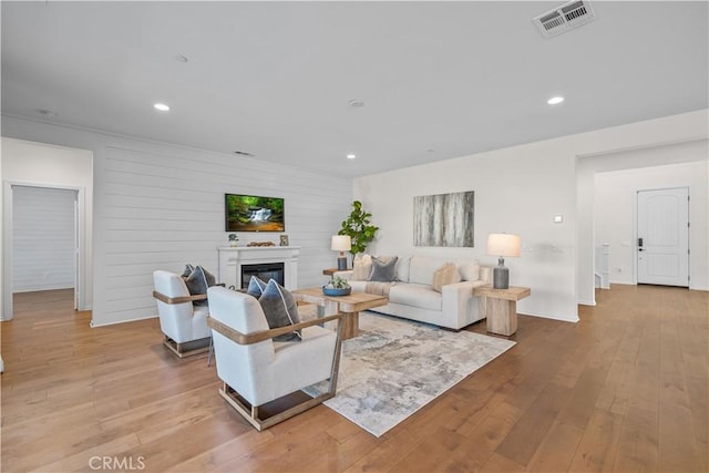 living room featuring wood walls and light wood-type flooring