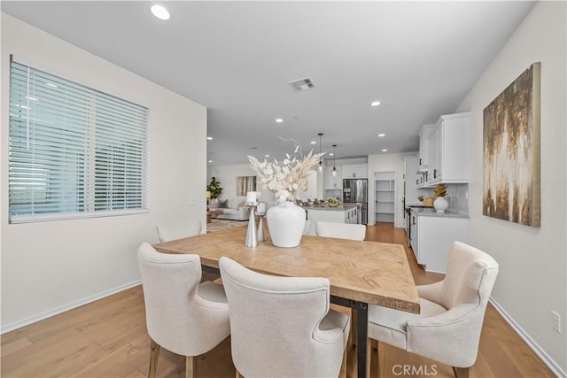 dining area with light hardwood / wood-style flooring