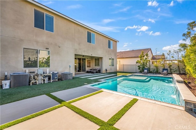 view of swimming pool featuring pool water feature and a patio