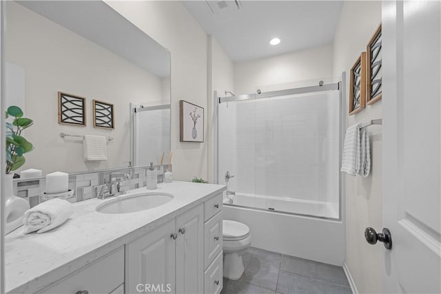 full bathroom with toilet, tile patterned flooring, enclosed tub / shower combo, and vanity