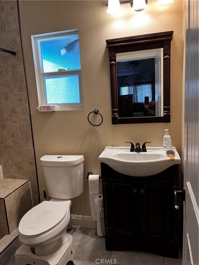 bathroom featuring toilet, vanity, and tile patterned floors