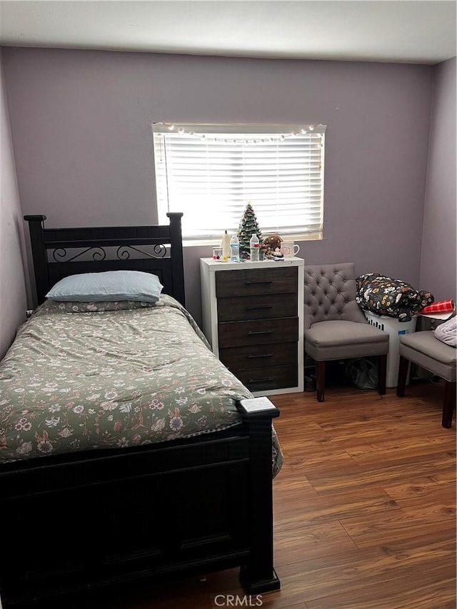 bedroom with hardwood / wood-style floors