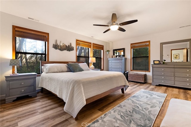 bedroom with ceiling fan and light hardwood / wood-style floors